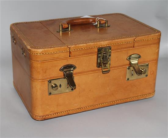 A tan leather travelling vanity case